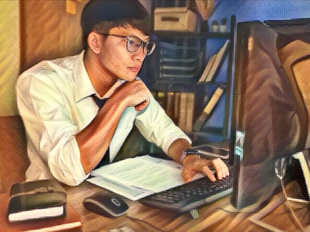 Young pensive asian man working late concentrated and serious in front of computer at night in dark office, Late night working or studying concept.
