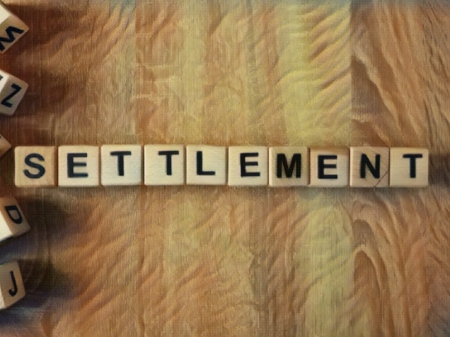 Settlement word from wooden blocks on desk