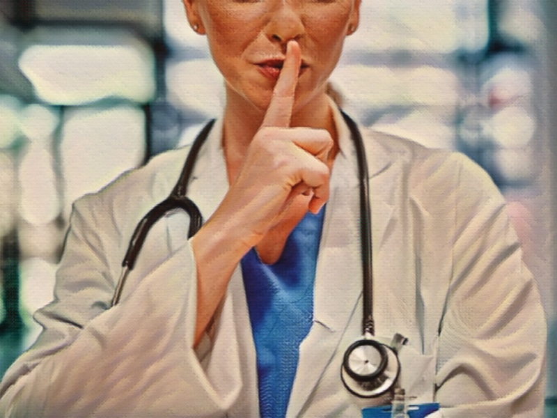 Shot of a doctor with her finger on her lips in a modern hospital