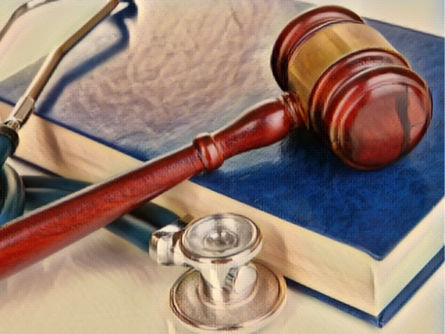 Gavel and stethoscope on book close up