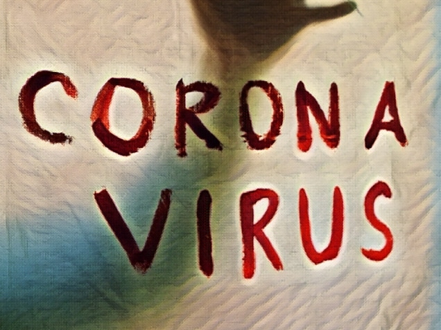 Corona Virus inscription on a white sheet. Silhouette of the hand behind the sheet. Coronavirus (Covid-19) disease outbreak. Quarantine.