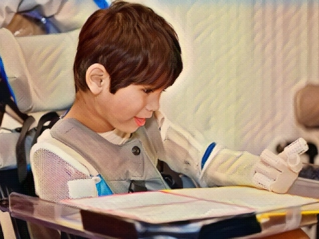 Five year old disabled boy studying in wheelchair. concept of Social Security Disability Benefits for Children