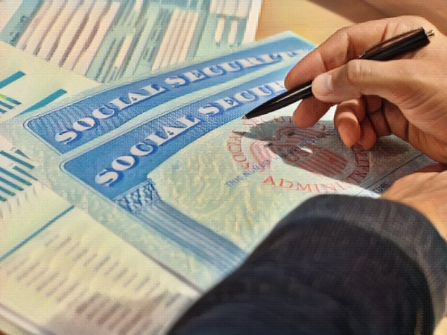 Closeup of person hand with pen filling Social Security blank. Concept of Social Security Disability and Facebook