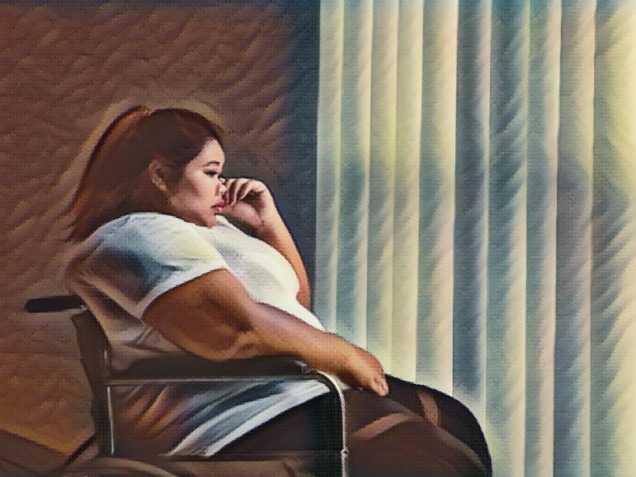 Disabled obese woman crying near the window