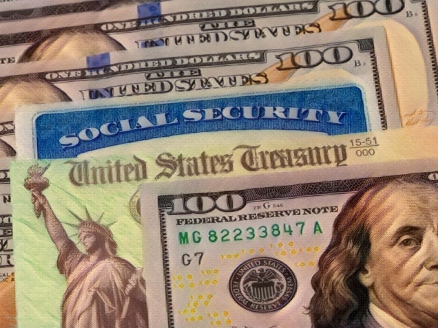 Social Security card, treasury check and 100 dollar bills.