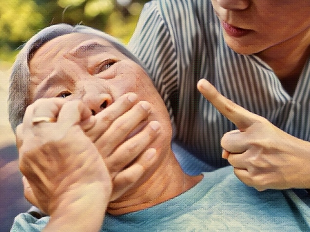 Angry asian woman covering senior mouth and showing silence gesture,