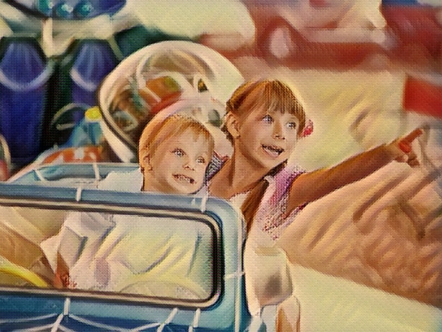 Brother and sister sitting in a toy car on a carousel in an amusement park