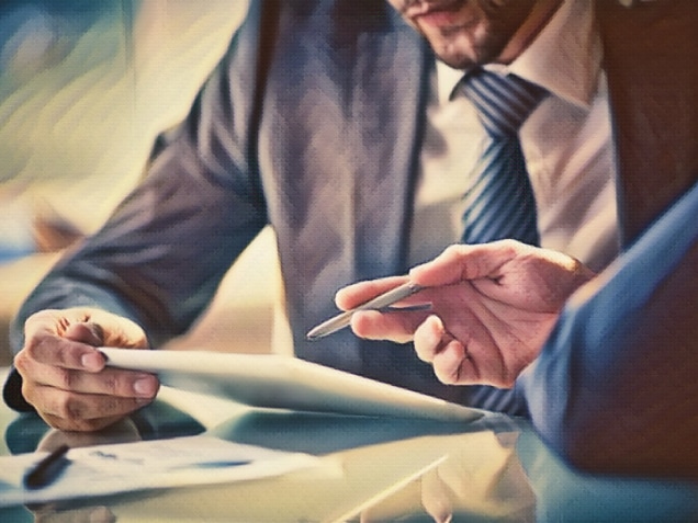 Image of two young businessmen using touchpad at meeting. Concept of the need for an experienced personal injury attorney