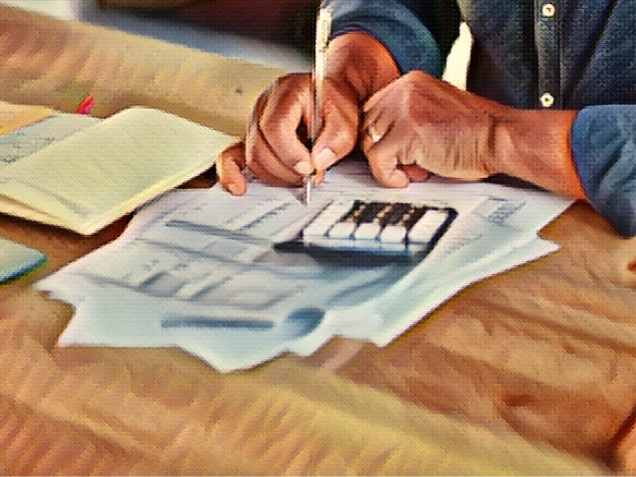 man calculating and going over his finances at home