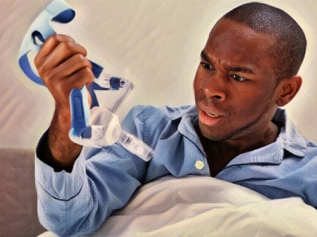 close-up of a young man looking at cpap mask