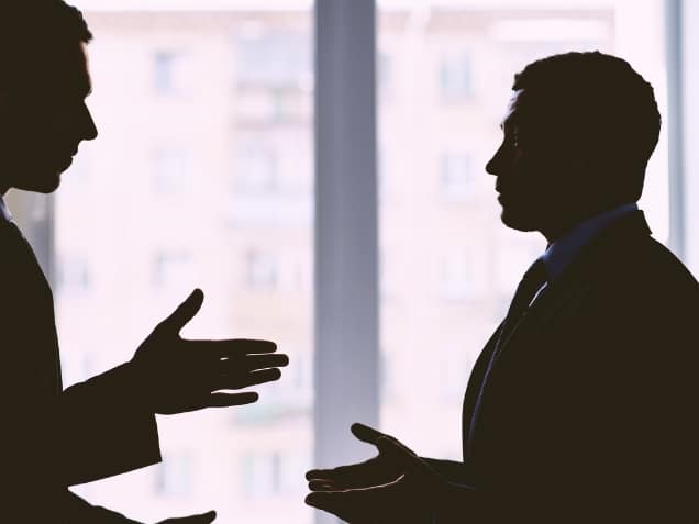 Silhouette of two men having disputes