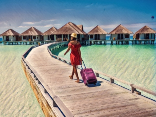 woman walking on a wooden bridge on her way to the villas