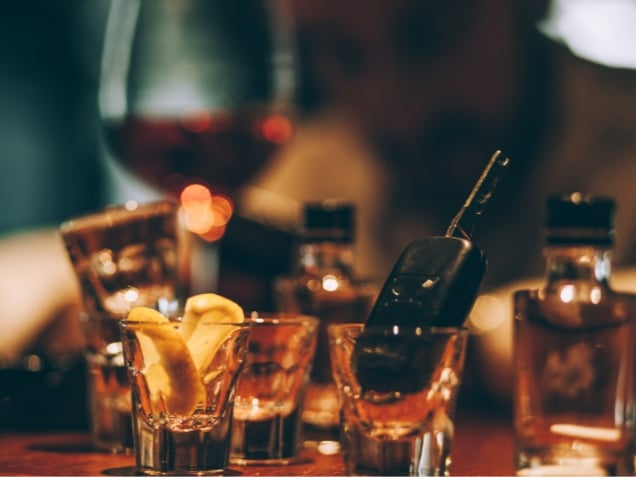 Young drunk man sitting in pub and holding car key