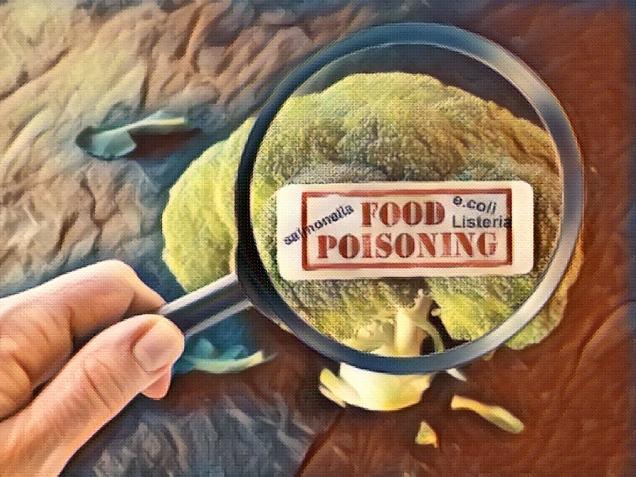 food poisoning label on broccoli examined by a person with magnifying glass