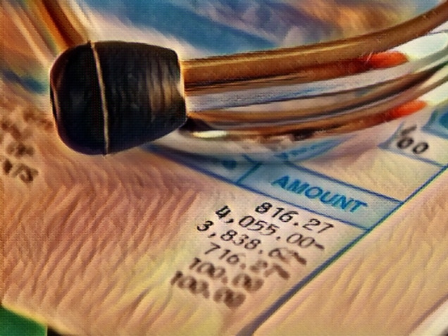 shot of medical bill and stethoscope