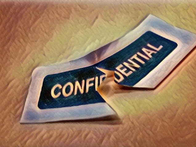 Paper with word confidential printed across representing a data breach or violation of confidentiality