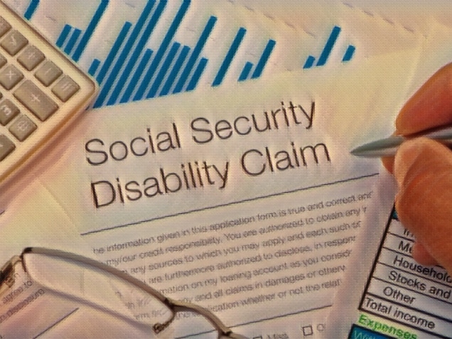 Close up of Social Security Disability Claim Form with writing hand