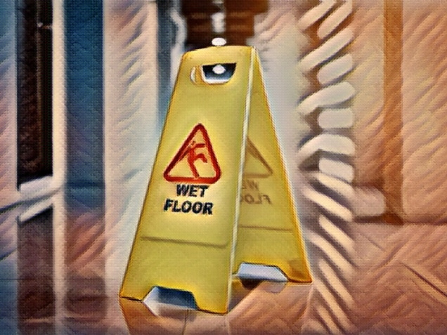 Sign showing warning of wet floor on wet floor