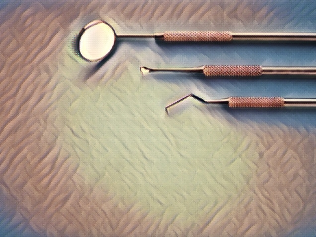 Dental instruments on blue.
