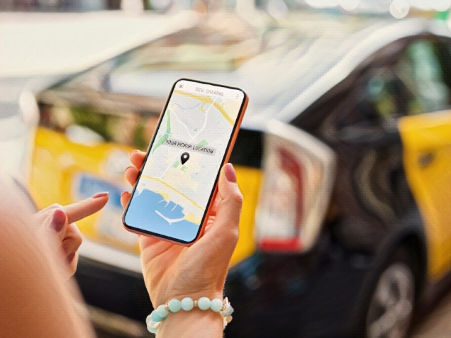 Person using taxi app on mobile phone