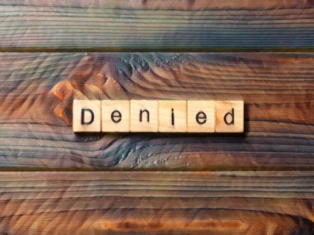word denied spelled on wooden blocks