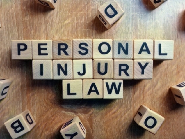Personal injury law text from wooden blocks on desk