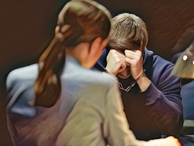 Desperate handcuffed suspect listening to prosecution charge. Concept of How to File a Civil Rights Complaint Against Police