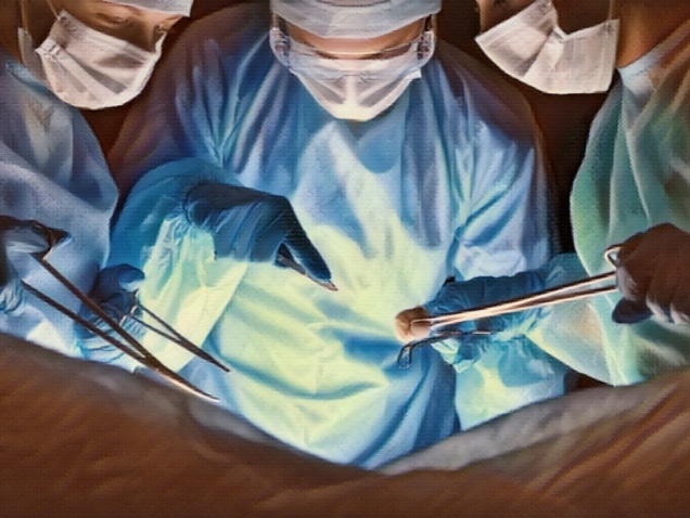 Group of surgeons in masks performing operation