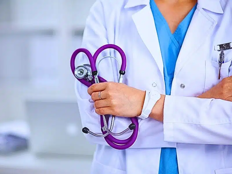 Female doctor holding a purple stethoscope. Misdiagnosis of stroke