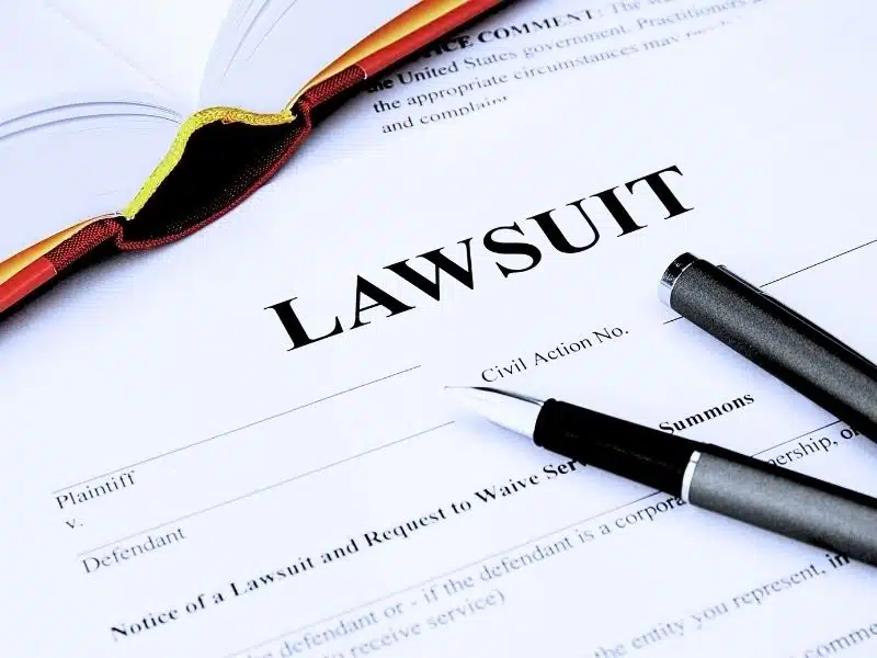 Lawsuit form with filler and a book. How do you win a mesothelioma case?