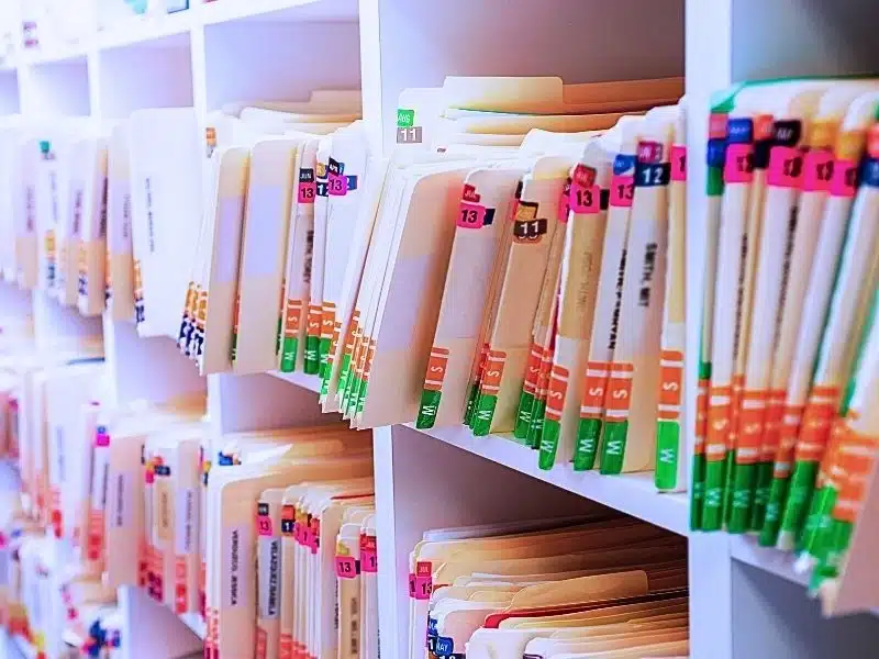 Horizontal image of a brightly lit filing cabinet full of medical records. How Long Do Medical Malpractice Lawsuits Usually Take?