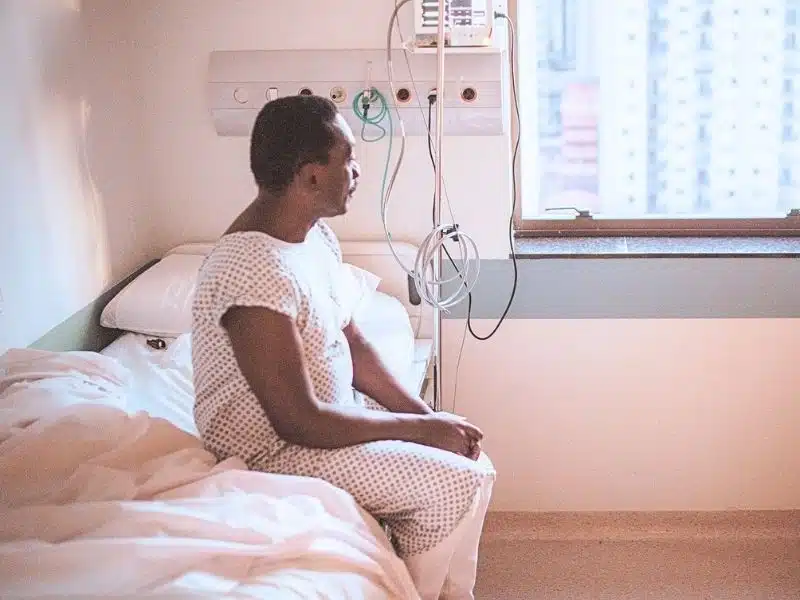 Senior patient looking through window at hospital. What diseases are linked to Roundup