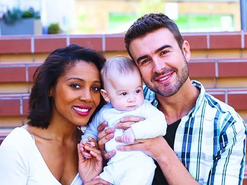 Happy interracial family. Enfamil recalled